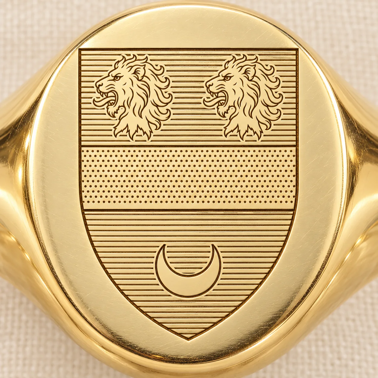 Close view of a crest engraved on the face of an oval signet ring